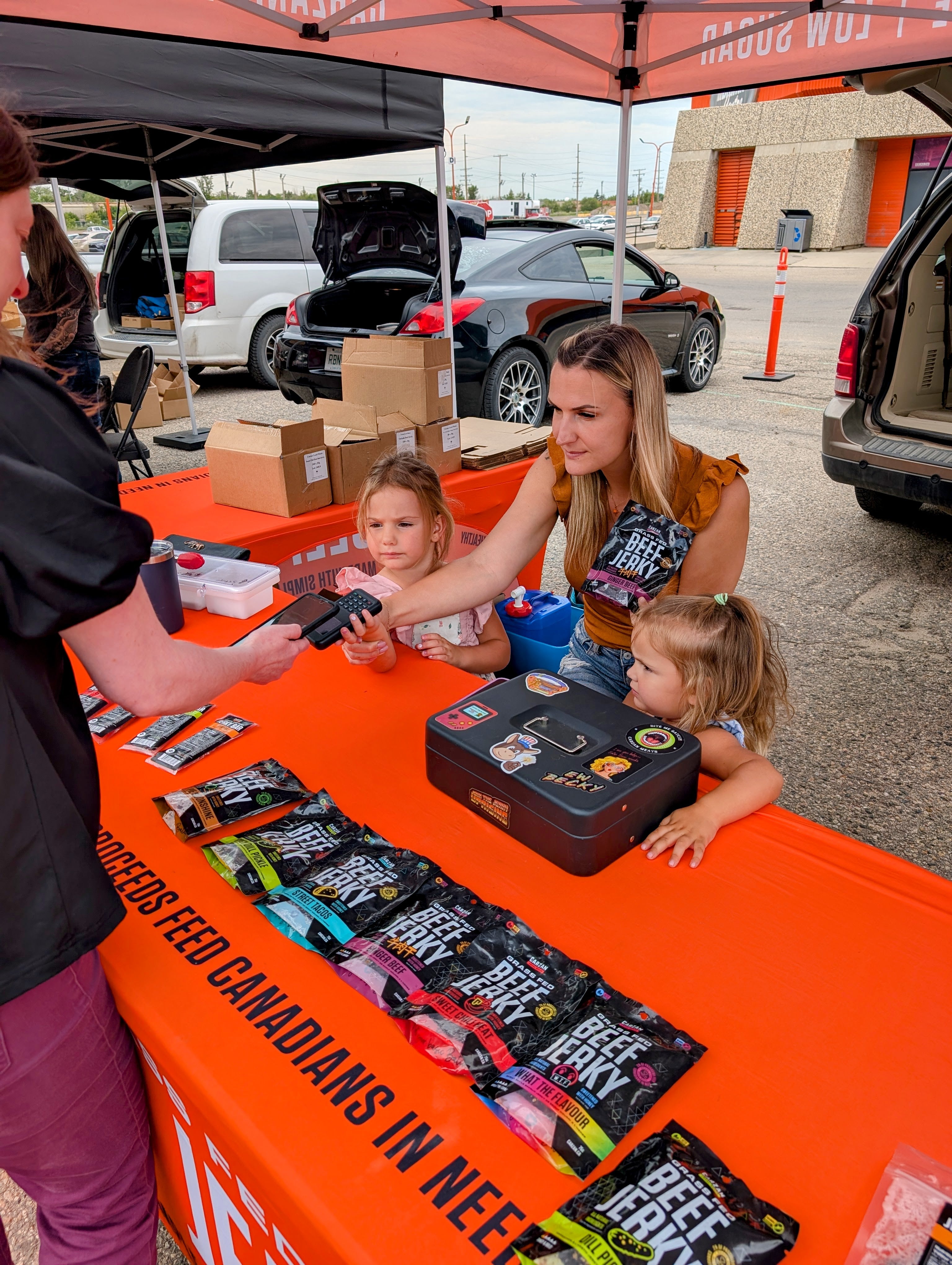 The whole family helping sell jerky at the farmer market