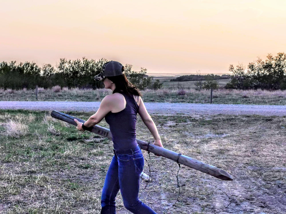 Carmen opening a gate on the ranch