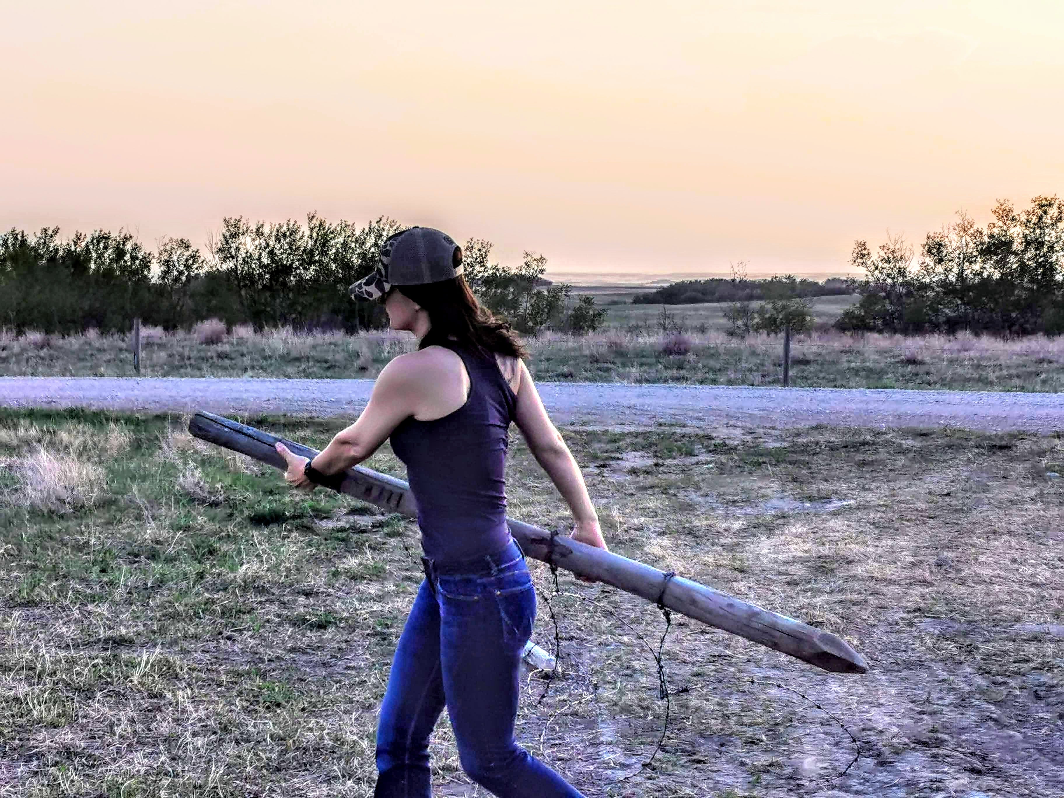 Carmen opening a gate on the ranch