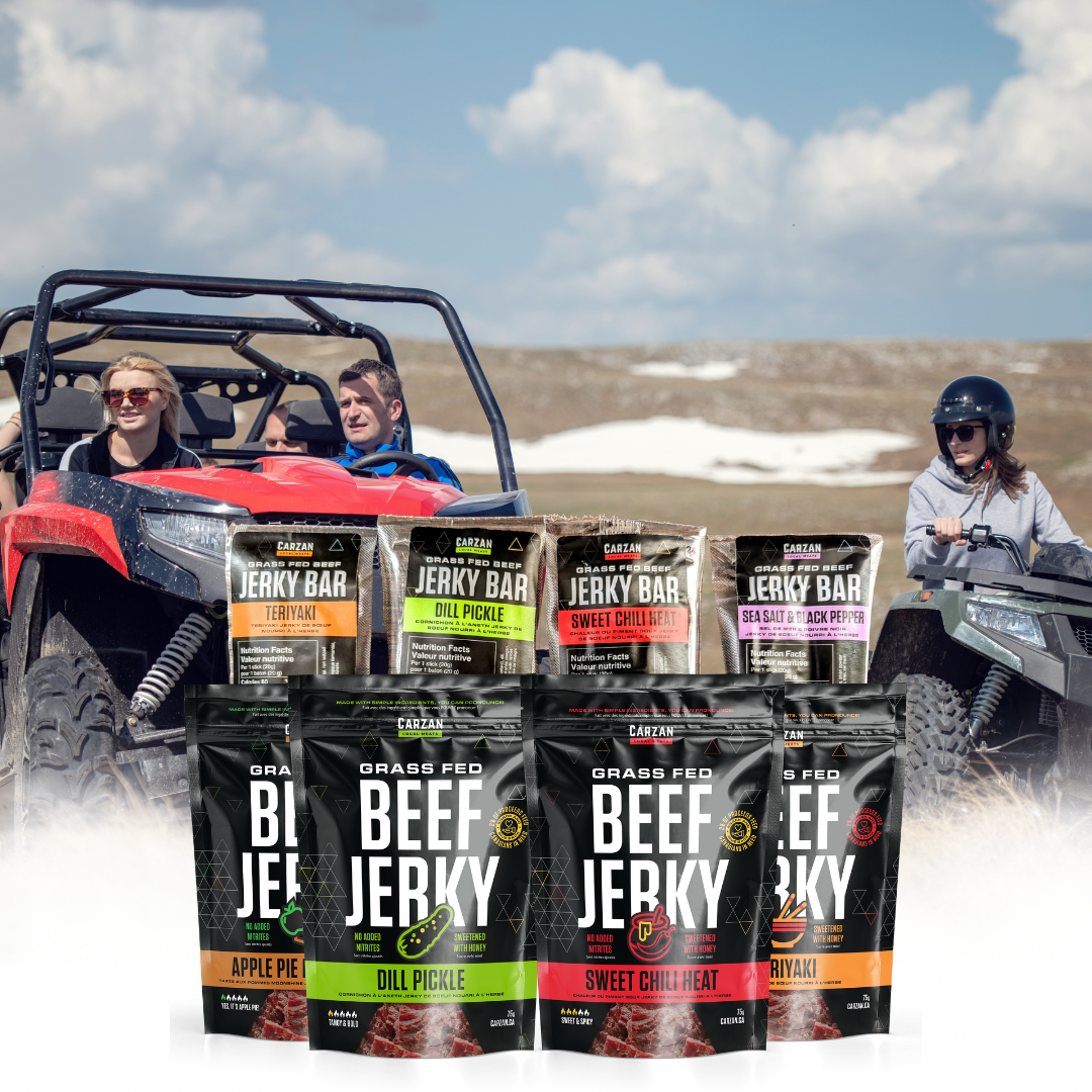 An image featuring a group of people with a vehicle in a outdoor setting, with an array of jerky snack packages in the foreground, including four jerky bars and four full-size jerky bags with different flavors.